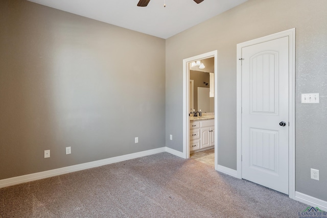 unfurnished bedroom with light carpet, ensuite bath, ceiling fan, and sink