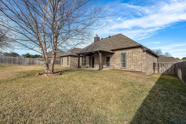 rear view of house featuring a lawn