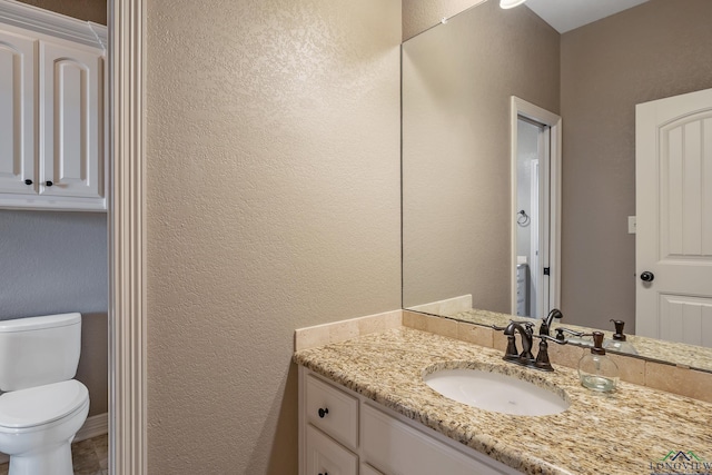 bathroom with toilet and vanity