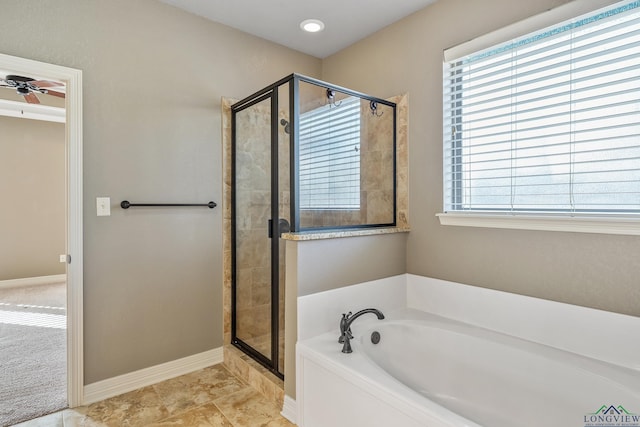 bathroom with ceiling fan, a wealth of natural light, and shower with separate bathtub