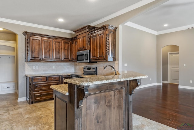 kitchen with sink, crown molding, light stone countertops, stainless steel appliances, and dark brown cabinets