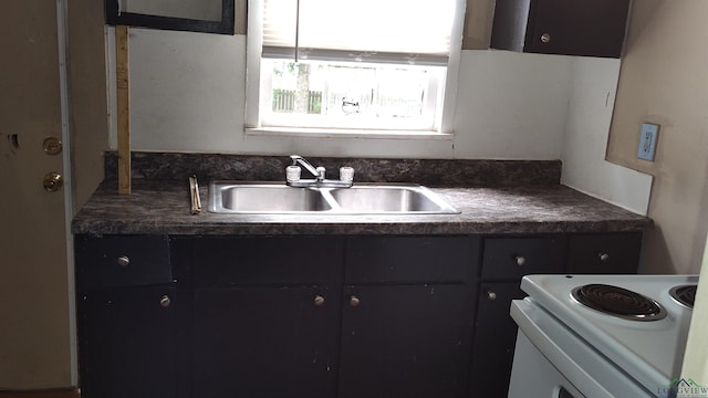 kitchen featuring white range with electric cooktop and sink