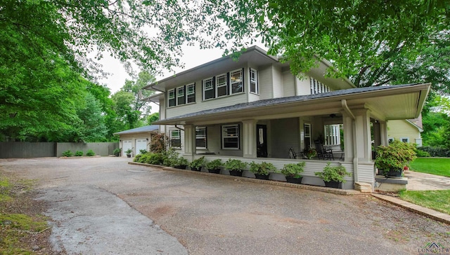 view of front facade featuring a porch and fence