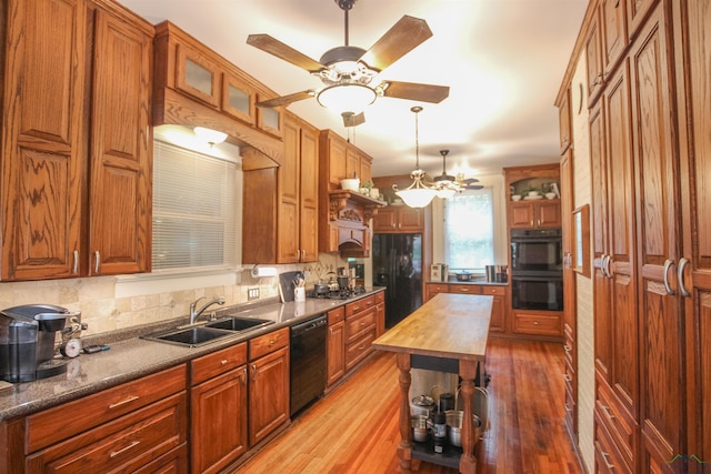 kitchen featuring a ceiling fan, butcher block counters, a sink, and black appliances
