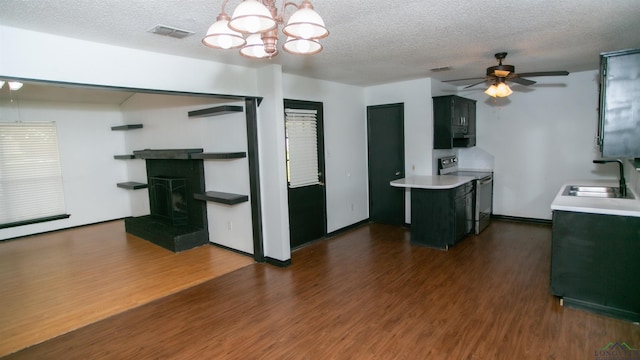 kitchen with dark hardwood / wood-style flooring, sink, stainless steel range with electric cooktop, and ceiling fan with notable chandelier