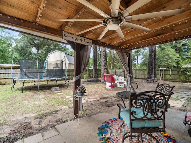 view of patio / terrace with ceiling fan and a trampoline