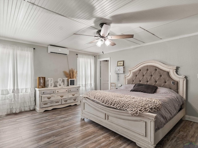 bedroom featuring wood-type flooring, a wall unit AC, ceiling fan, and crown molding