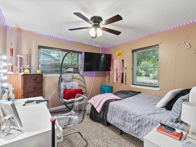 bedroom with a textured ceiling and ceiling fan