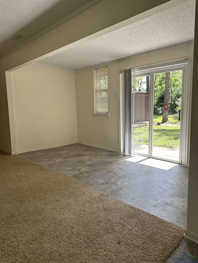 unfurnished room featuring ornamental molding and a textured ceiling