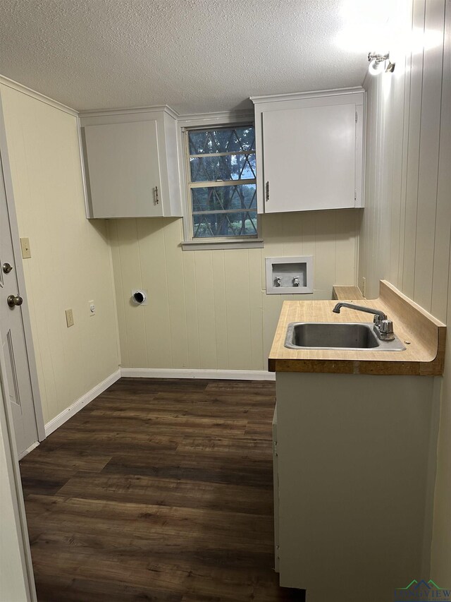 laundry room with hookup for a washing machine, sink, dark wood-type flooring, and cabinets