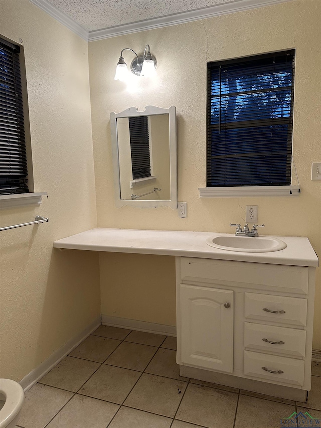 bathroom with tile patterned flooring, vanity, crown molding, and a textured ceiling