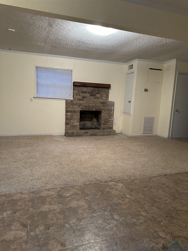 unfurnished living room featuring carpet flooring, a brick fireplace, and a textured ceiling