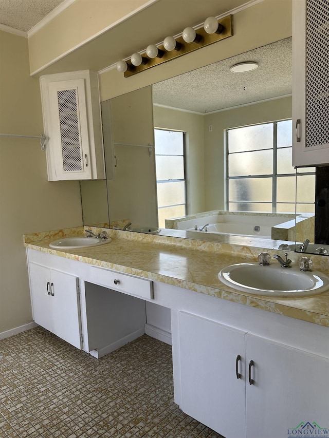 bathroom with crown molding, vanity, and a textured ceiling