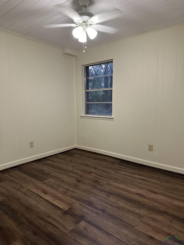 spare room with dark wood-type flooring and ceiling fan