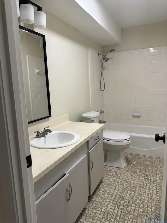 full bathroom with vanity, tiled shower / bath combo, and toilet