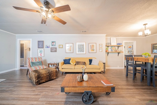 living room with hardwood / wood-style flooring, crown molding, ceiling fan with notable chandelier, and a textured ceiling