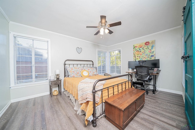 bedroom featuring hardwood / wood-style flooring, ornamental molding, and ceiling fan