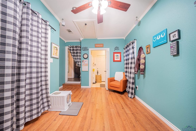 unfurnished room featuring ornamental molding, ceiling fan, and light hardwood / wood-style flooring