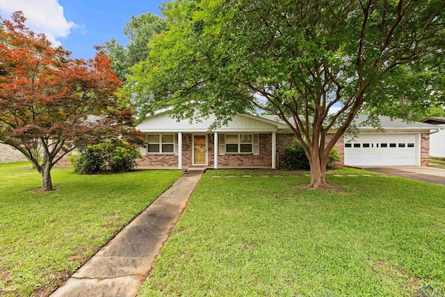 view of front of property featuring brick siding, driveway, a garage, and a front lawn