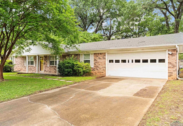 ranch-style house with brick siding, concrete driveway, a garage, and a front lawn