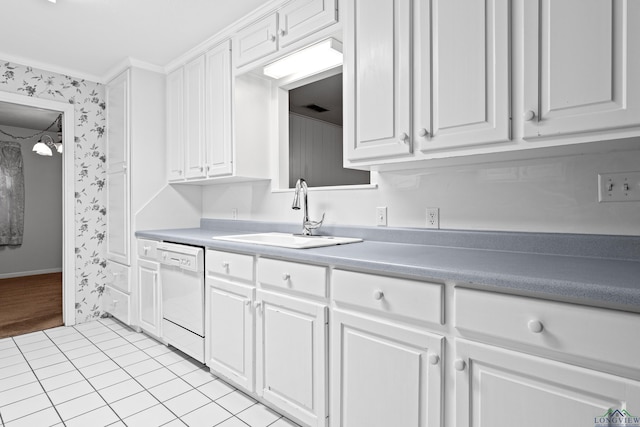 kitchen with dishwasher, a sink, wallpapered walls, white cabinets, and light tile patterned floors