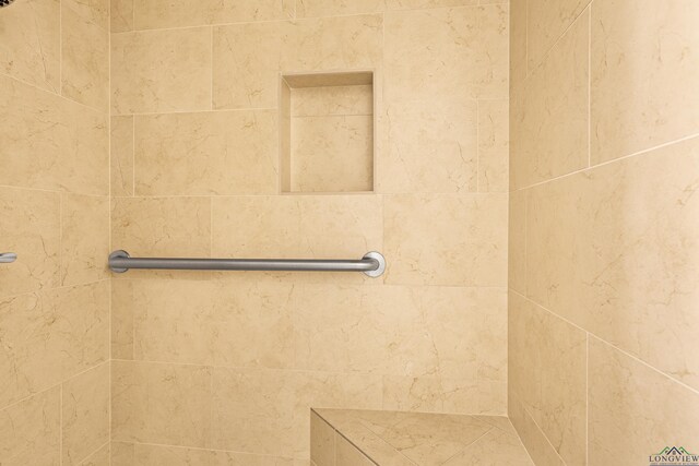 bathroom with tiled shower