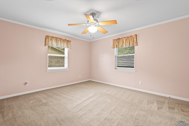 carpeted empty room featuring ornamental molding, baseboards, plenty of natural light, and ceiling fan