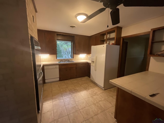 402 Mark Dr, Marshall, TX 75672 - kitchen with tile counters, sink, ceiling fan, and white appliances