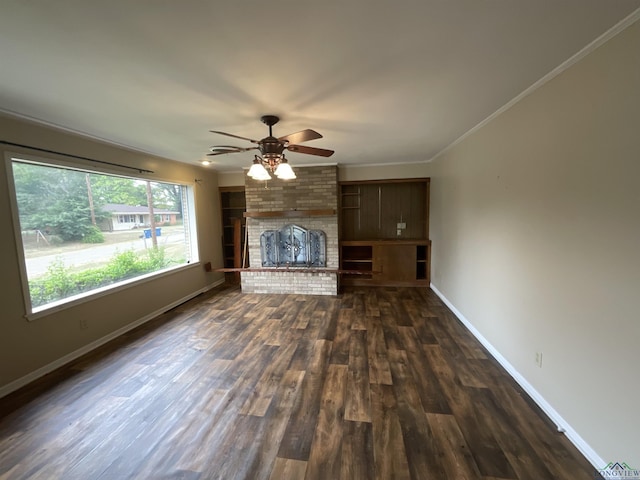 unfurnished living room with a fireplace, dark hardwood / wood-style flooring, ceiling fan, and crown molding