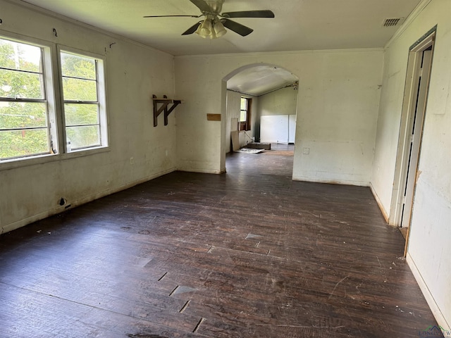 empty room with ceiling fan, dark hardwood / wood-style floors, and ornamental molding