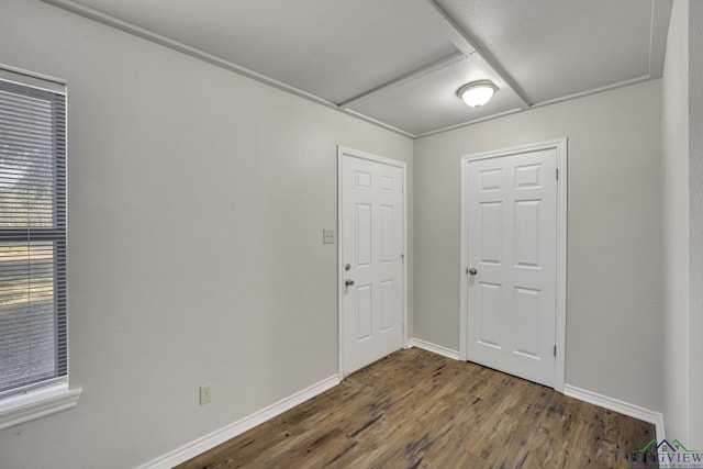 unfurnished room with dark hardwood / wood-style flooring