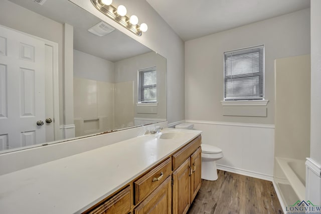 bathroom with wood-type flooring, vanity, and toilet