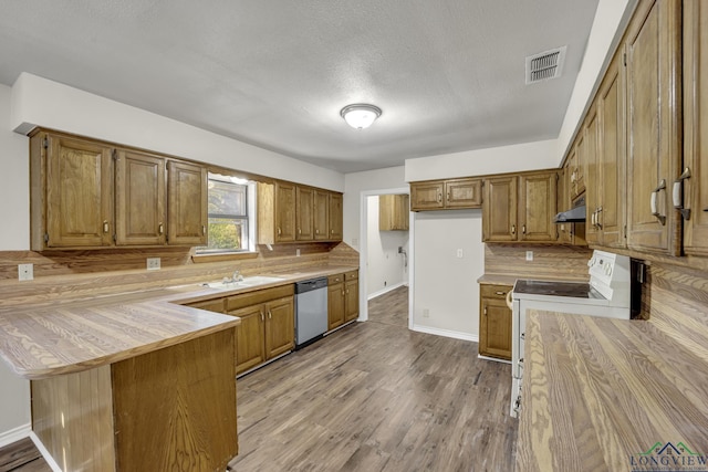 kitchen featuring white range with electric stovetop, dishwasher, sink, light hardwood / wood-style floors, and kitchen peninsula