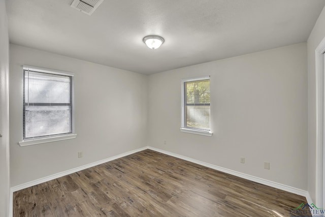 spare room with dark wood-type flooring