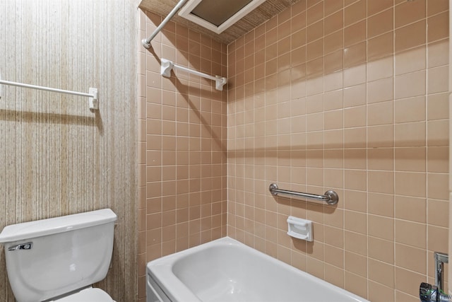 bathroom with bathtub / shower combination and toilet