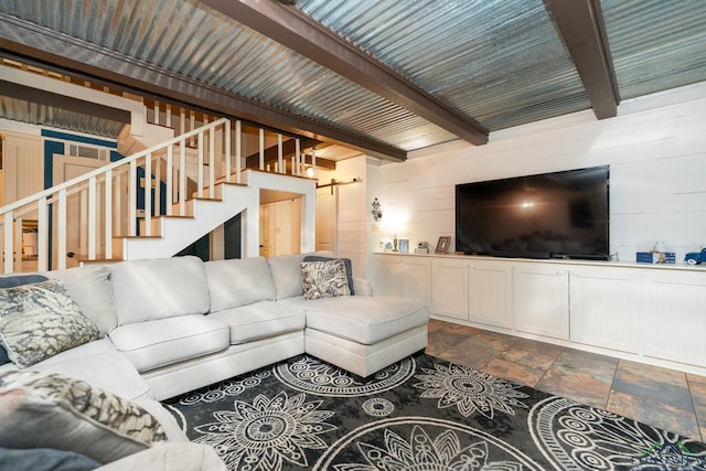 901 N Whatley Rd, White, TX 75693 - living room with dark stone finish flooring, wood walls, stairway, beamed ceiling, and a barn door