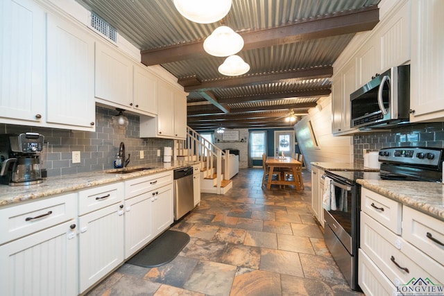 901 N Whatley Rd, White, TX 75693 - kitchen featuring appliances with stainless steel finishes, a sink, stone tile flooring, backsplash, and white cabinetry