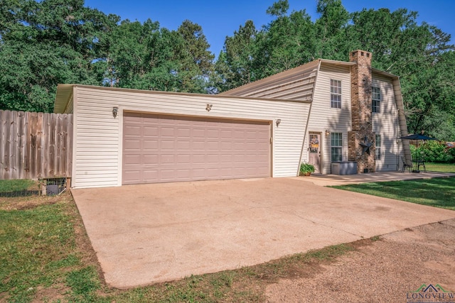 901 N Whatley Rd, White, TX 75693 - mid-century modern home featuring a chimney, an attached garage, and concrete driveway