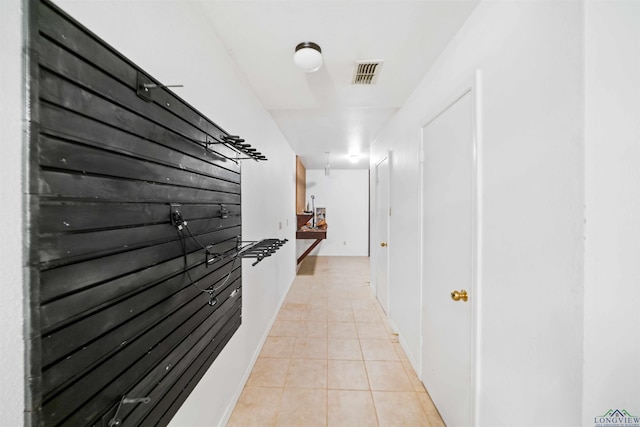 corridor featuring light tile patterned floors and visible vents