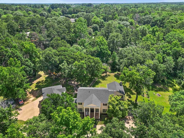 birds eye view of property with a view of trees