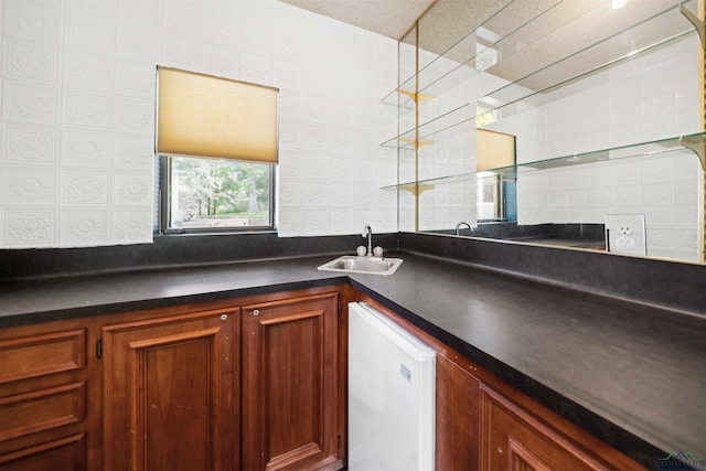 bar featuring a sink, wet bar, and white dishwasher