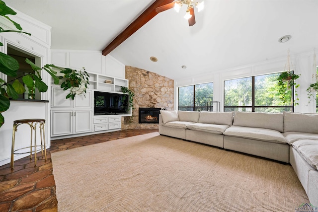 unfurnished living room featuring a fireplace, lofted ceiling with beams, and a ceiling fan