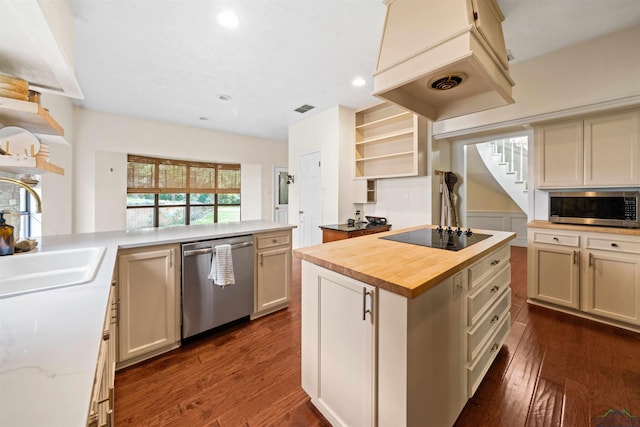 kitchen featuring open shelves, premium range hood, butcher block countertops, stainless steel appliances, and a sink