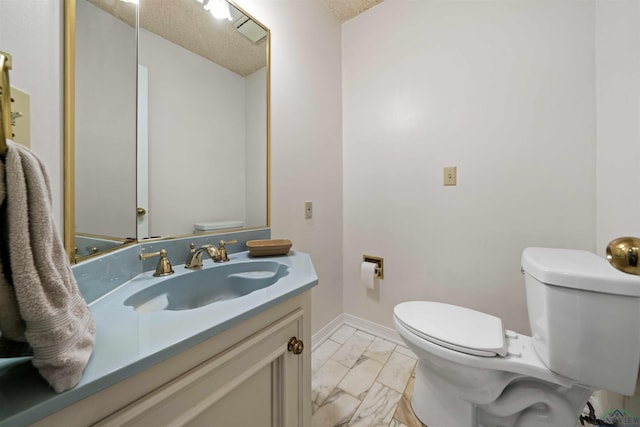 half bath with baseboards, toilet, vanity, marble finish floor, and a textured ceiling