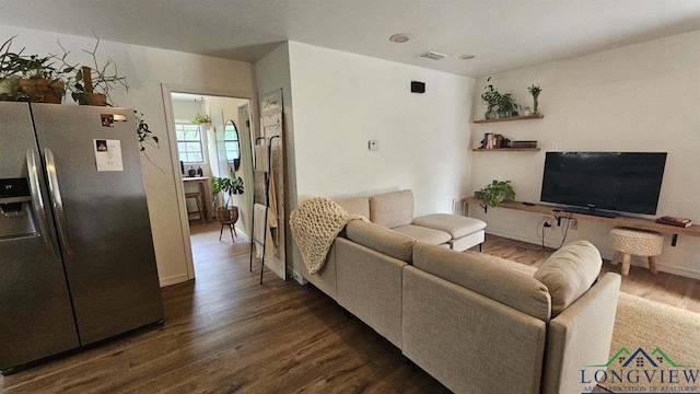 living area with dark wood finished floors and visible vents