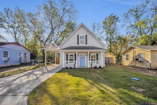 view of front of property featuring cooling unit, a front yard, and a porch