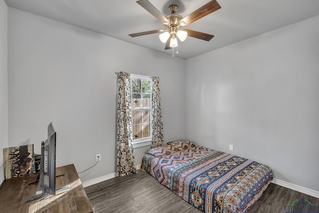 bedroom with dark hardwood / wood-style floors and ceiling fan