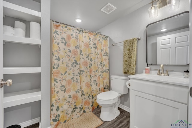 bathroom featuring hardwood / wood-style flooring, vanity, a shower with shower curtain, and toilet