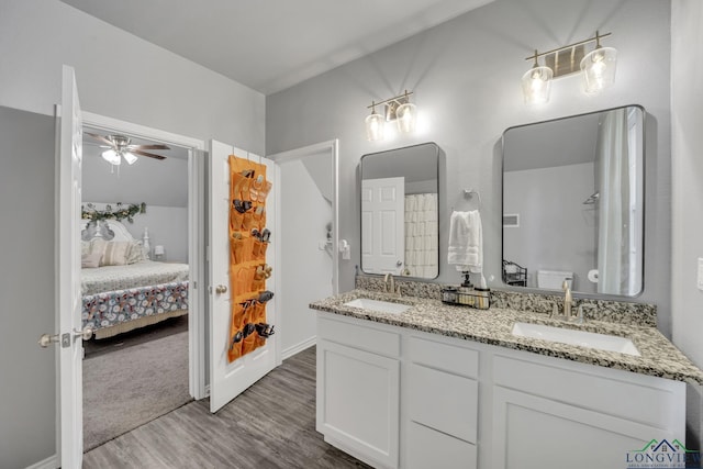 bathroom with wood-type flooring, vanity, toilet, and ceiling fan