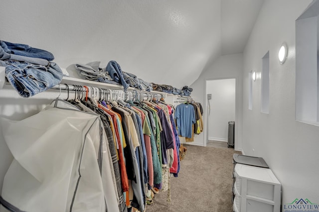 spacious closet with carpet and lofted ceiling